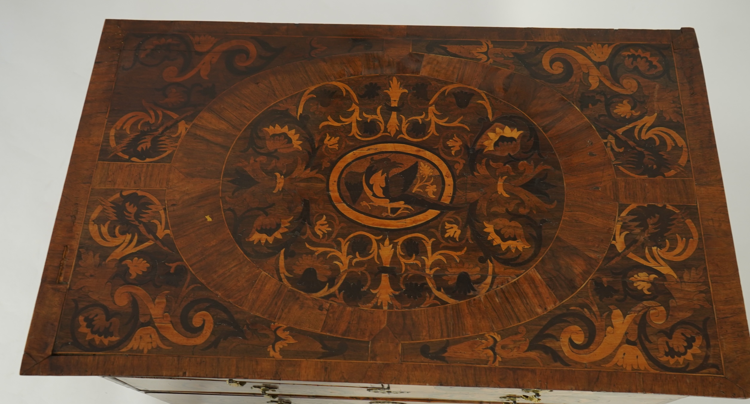 A William and Mary walnut and floral marquetry chest on later bracket feet